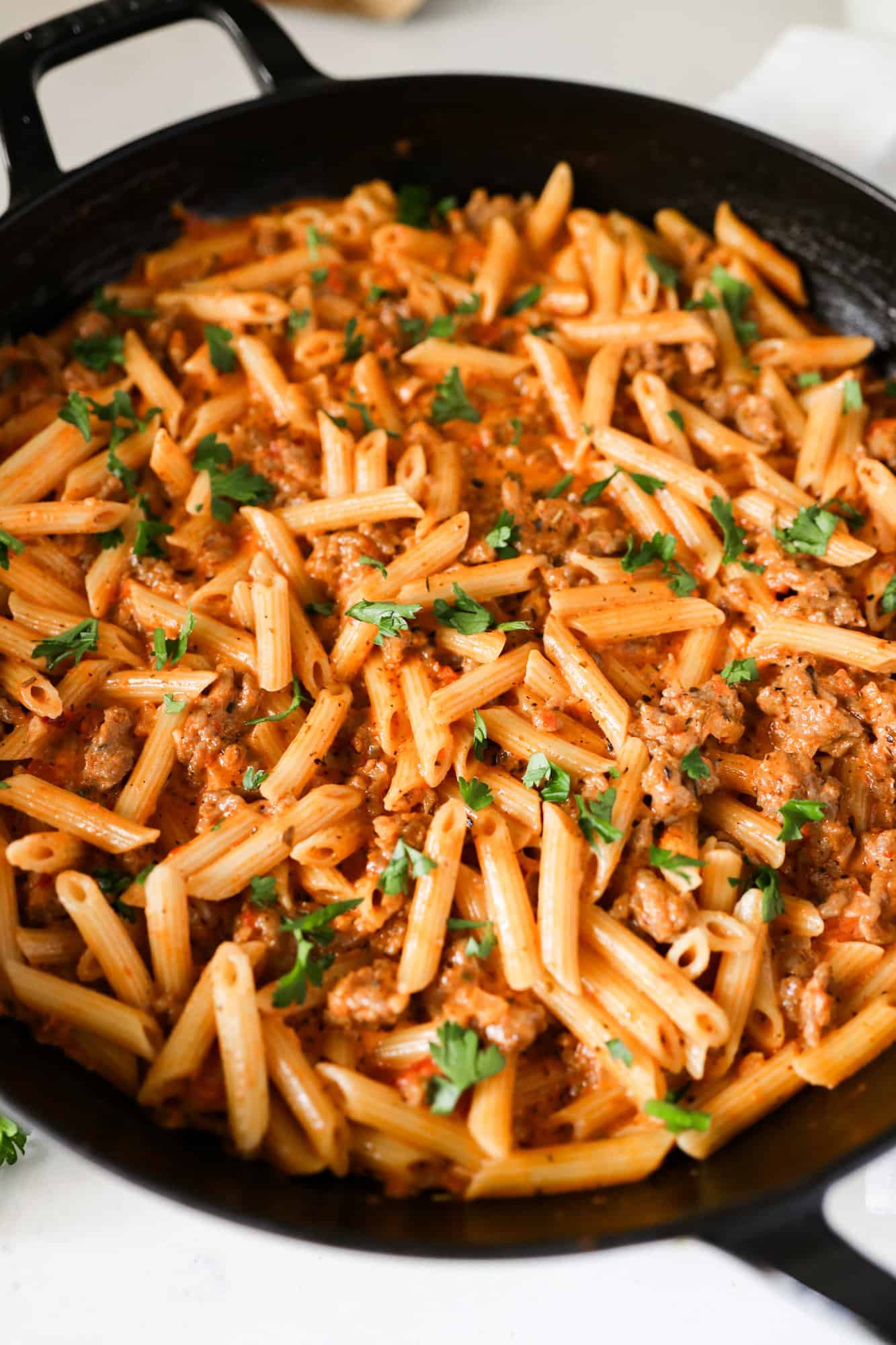 Creamy Italian Sausage Pasta in a skillet side close up view