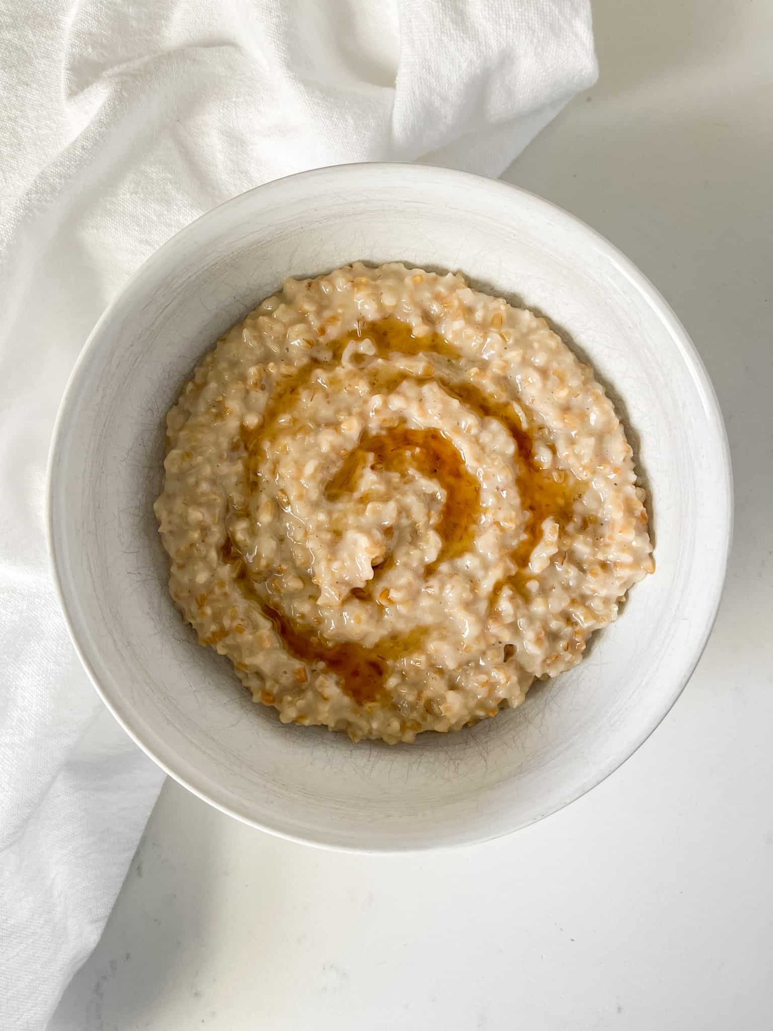 Steel Cut Oatmeal with Maple Syrup served in a white bowl.